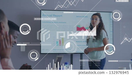 Woman in green blouse presenting data on display in conference room, with infographics, copy space 132976945