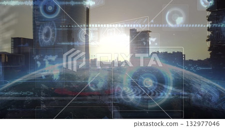 Holographic overlay floating over city skyline at sunrise, with radar displays and globe projection 132977046