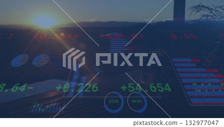 Displaying holographic overlay on balcony overlooking valley at sunset with dials and bar graphs 132977047