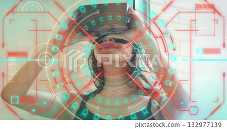 Asian woman in black tank top holding VR headset and viewing holographic display in minimalist room Asian woman in black tank top holding VR headset and viewing holographic display in minimalist room 132977139