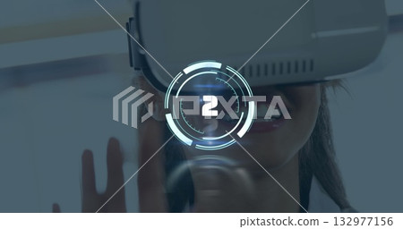 Smiling woman wearing white VR headset using holographic countdown HUD at tech demo, hand gesture Smiling woman wearing white VR headset using holographic countdown HUD at tech demo, hand gesture 132977156