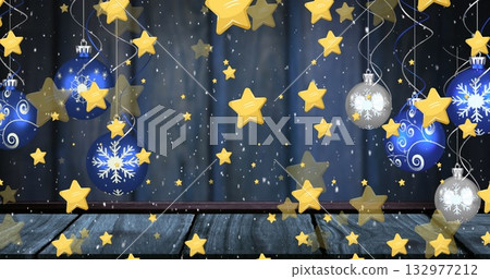 Hanging blue-silver baubles and golden stars from silver ribbons above wooden floor, navy curtain 132977212