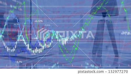 Displaying composite financial data chart at wooden desk beside window, with laptop and coffee mug 132977270