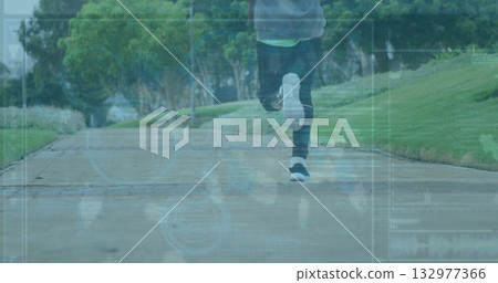 Running male wearing leggings and sneakers on concrete park path with grass banks and HUD data 132977366