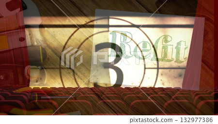 Showing vintage countdown number three Refit on screen at cinema with red seats and projector 132977386