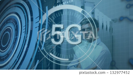 Standing telecom engineer crossing arms in data center with racks, cables and 5G overlay copy space Standing telecom engineer crossing arms in data center with racks, cables and 5G overlay copy space 132977452