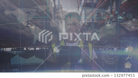 Worker wearing safety vest scanning racks with tablet in warehouse aisle with holographic overlay 132977453