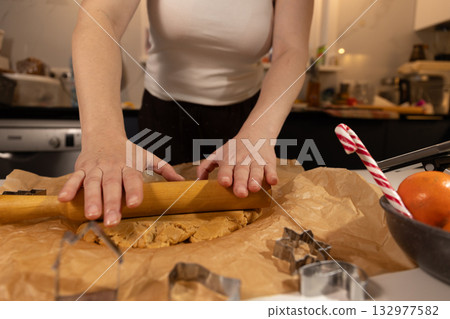 Woman Rolls Gingerbread Dough in Kitchen for Christmas Holiday Baking Woman Rolls Gingerbread Dough in Kitchen for Christmas Holiday Baking 132977582