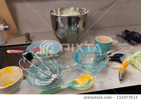 Messy Kitchen Scene With Bowls and Utensils From Baking Meringue and Whipped Cream Messy Kitchen Scene With Bowls and Utensils From Baking Meringue and Whipped Cream 132977613