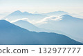 Misty mountain layers at sunrise for concept of nature, adventure, travel, or peaceful landscape 132977777