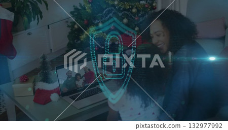 Chatting family members sharing virtual holiday call in living room, with laptop and Christmas tree Chatting family members sharing virtual holiday call in living room, with laptop and Christmas tree 132977992
