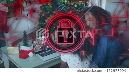 Mother and daughter watching Santa Claus on laptop in living room, with stocking, gifts and tree Mother and daughter watching Santa Claus on laptop in living room, with stocking, gifts and tree 132977994