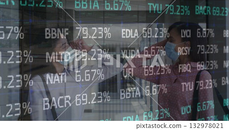 Elbow bumping two masked businesswomen exchanging greeting at transit hub, ticker display 132978021