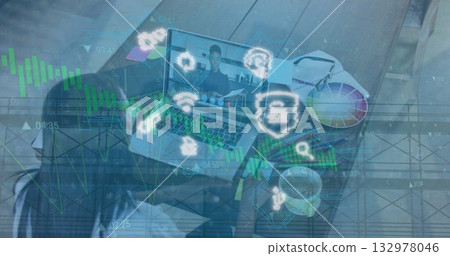 Displaying laptop showing call with colleague holding documents in home office with color palette Displaying laptop showing call with colleague holding documents in home office with color palette 132978046