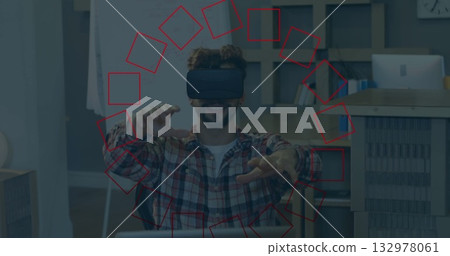 Reaching man wearing VR headset, plaid shirt at office desk, with laptop, whiteboard and shelf Reaching man wearing VR headset, plaid shirt at office desk, with laptop, whiteboard and shelf 132978061