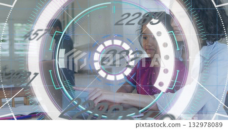 Pointing girl in red top interacting with holographic interface in home kitchen, with laptop 132978089