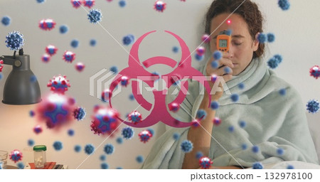 Measuring woman with infrared thermometer at home, pills, virus graphics and biohazard, copy space Measuring woman with infrared thermometer at home, pills, virus graphics and biohazard, copy space 132978100