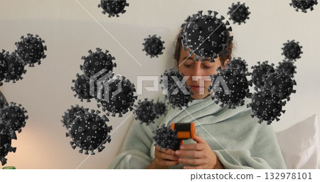 Woman wrapped in green blanket using thermometer to measure temperature in bedroom, virus overlay Woman wrapped in green blanket using thermometer to measure temperature in bedroom, virus overlay 132978101