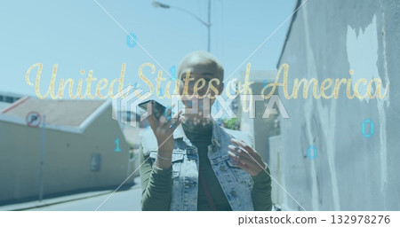 Walking woman holding smartphone on urban street, binary overlay with United States of America text Walking woman holding smartphone on urban street, binary overlay with United States of America text 132978276