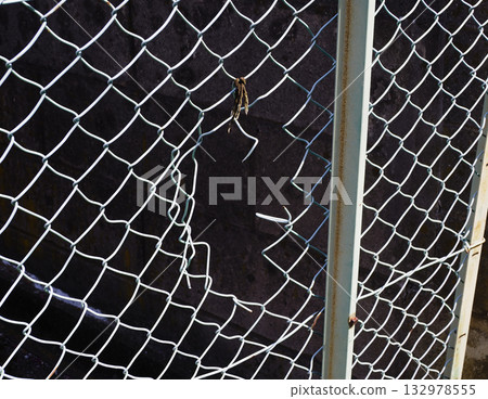 Torn wire mesh 132978555