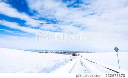 A winter sky with blue skies and a packed snow road in Biei, Hokkaido 132978878