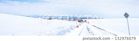 A winter sky with blue skies and a packed snow road in Biei, Hokkaido 132978879
