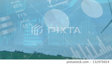 Overlaying semi-transparent graphs percentages and world map on rural hill, with wind turbine blade 132978924
