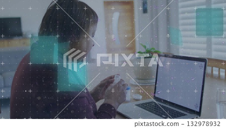 Twisting lid on white container at home office desk, with open laptop and plant, copy space 132978932