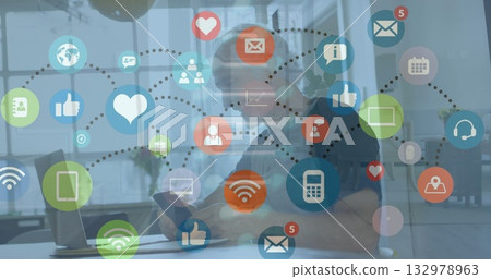 Browsing professional wearing polo scrolling phone notifications at desk with laptop, digital icons Browsing professional wearing polo scrolling phone notifications at desk with laptop, digital icons 132978963