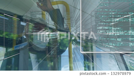 Standing male commuter gripping yellow handrail in bus, with Covid-19 poster and code panels 132978979