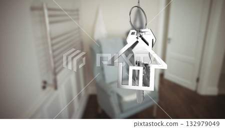 Hanging house-shaped keychain showing silver keys in home entryway, armchair, towel radiator 132979049