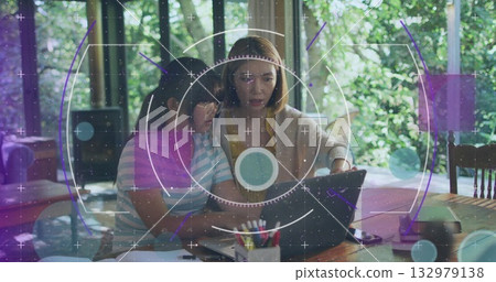 Mother and daughter studying in dining nook, with laptop notebooks colored pencils and black device Mother and daughter studying in dining nook, with laptop notebooks colored pencils and black device 132979138