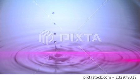 Hovering water droplet creating ripples on liquid surface at studio, with neon-pink reflection line Hovering water droplet creating ripples on liquid surface at studio, with neon-pink reflection line 132979312