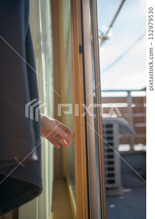 Housewife opening the window Housewife opening the window 132979530