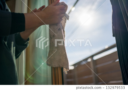 Housewife cleaning windows 132979533