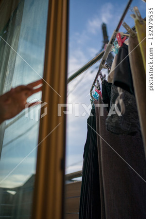 Housewife opening the window 132979535