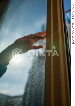 Housewife opening the window 132979536
