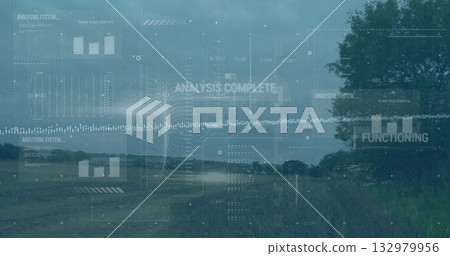 Displaying digital analytic overlay over countryside field beneath cloudy sky, featuring data grids 132979956