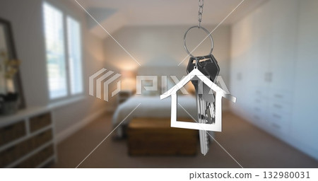 Hanging metal key ring featuring several keys in bedroom interior, with house-shaped charm 132980031