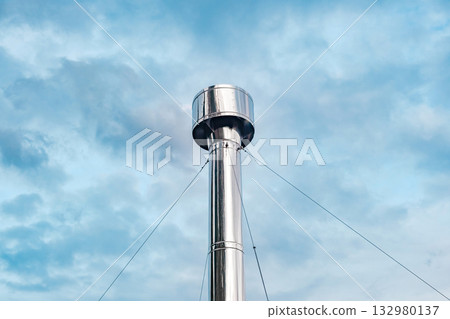metal round chimney close-up on sky background metal round chimney close-up on sky background 132980137