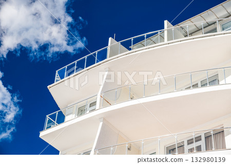 balconies of residential building close-up against blue sky background balconies of residential building close-up against blue sky background 132980139