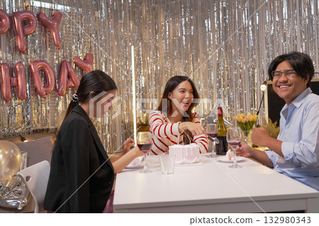 Group of Friends Celebrating Birthday Party with Cake and Gifts 132980343