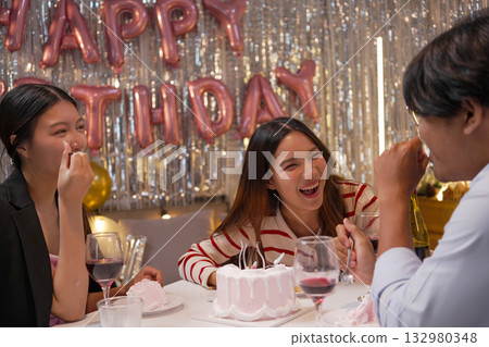 Group of Friends Celebrating Birthday Party with Cake and Gifts 132980348