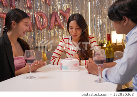 Group of Friends Celebrating Birthday Party with Cake and Gifts 132980368