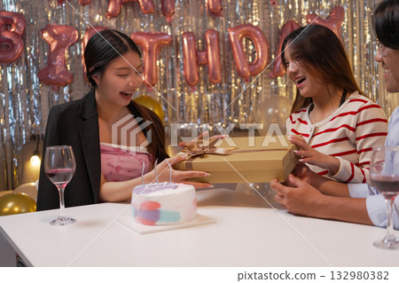 Group of Friends Celebrating Birthday Party with Cake and Gifts Group of Friends Celebrating Birthday Party with Cake and Gifts 132980382