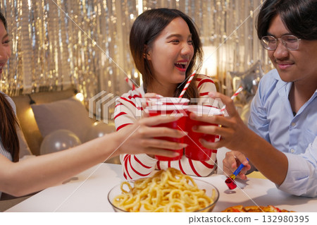 Group of Friends Celebrating Birthday Party with Cake and Gifts Group of Friends Celebrating Birthday Party with Cake and Gifts 132980395