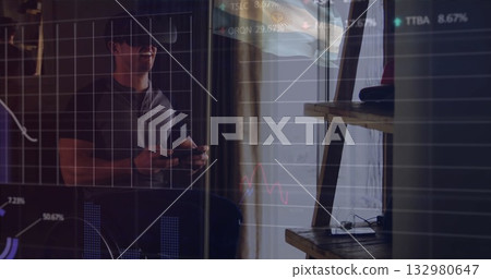 Man wearing VR headset and holding controllers exploring virtual financial charts in home office Man wearing VR headset and holding controllers exploring virtual financial charts in home office 132980647