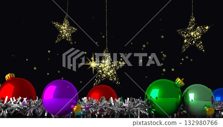 Displaying colorful Christmas baubles in silver tinsel on shelf, with hanging golden star ornaments Displaying colorful Christmas baubles in silver tinsel on shelf, with hanging golden star ornaments 132980766