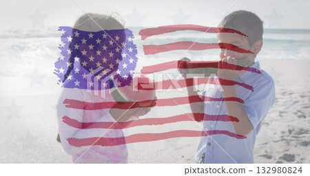 Siblings wearing dress and blue shirt holding green apples on beach, with American flag overlay 132980824