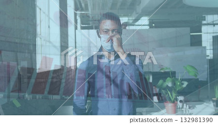 Positioning man wearing shirt placing medical mask over nose in workspace, with bar chart overlay Positioning man wearing shirt placing medical mask over nose in workspace, with bar chart overlay 132981390
